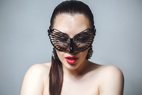 Cute woman wearing black butterfly mask Stock Photo 09