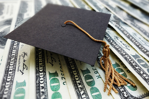 Dollar under the graduation cap Stock Photo