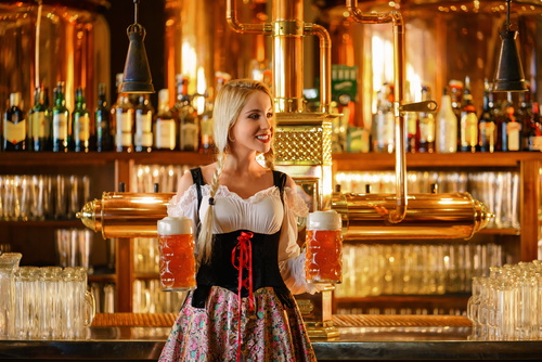 Dressed in national costumes smiling waitress bar Stock Photo