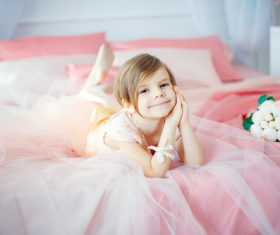 Dressed up beautiful little girl sitting on the bed Stock Photo 05