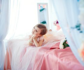 Dressed up beautiful little girl sitting on the bed Stock Photo 06