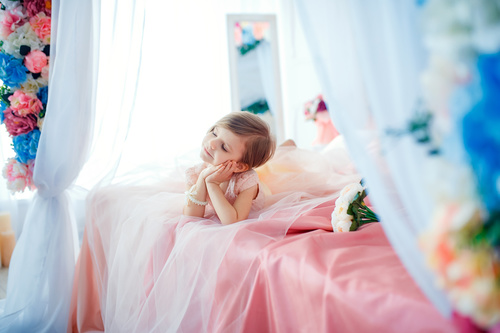 Dressed up beautiful little girl sitting on the bed Stock Photo 06