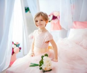 Dressed up beautiful little girl sitting on the bed Stock Photo 08
