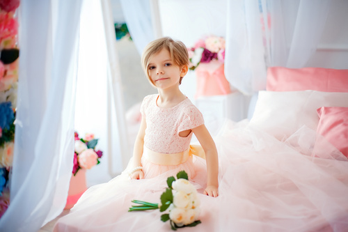 Dressed up beautiful little girl sitting on the bed Stock Photo 08
