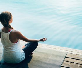 Early morning woman practicing yoga by the lake Stock Photo 01