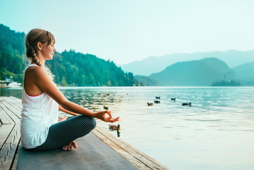 Early morning woman practicing yoga by the lake Stock Photo 10
