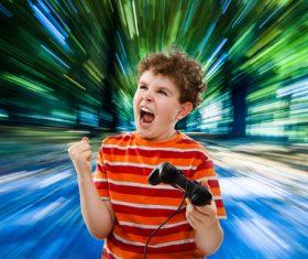 Excited boy playing games Stock Photo