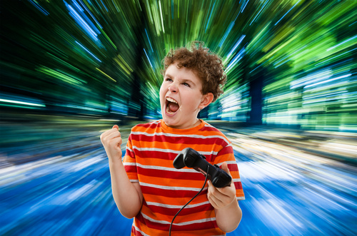 Excited boy playing games Stock Photo