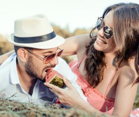 Feeding boyfriend to eat watermelon Stock Photo