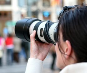 Female photographer shooting street scene Stock Photo