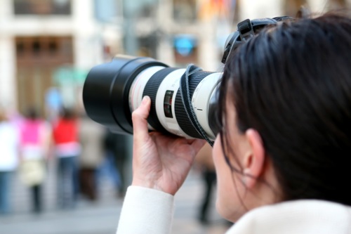 Female photographer shooting street scene Stock Photo