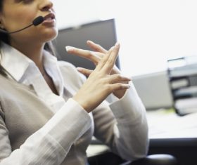 Female white collar wearing headset talking Stock Photo