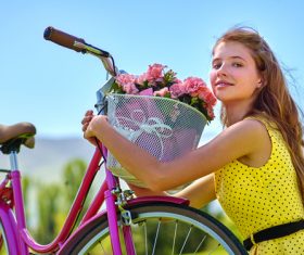 Girl hugs car basket of flowers Stock Photo