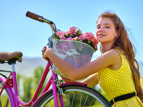 Girl hugs car basket of flowers Stock Photo