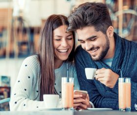 Happy couple chatting in cafe Stock Photo