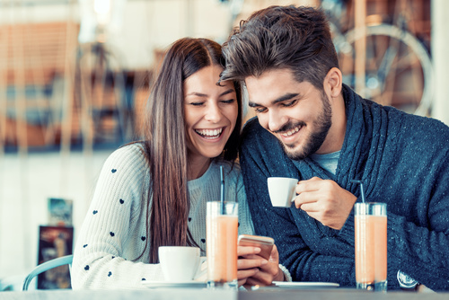 Happy couple chatting in cafe Stock Photo