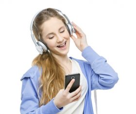 Happy girl listening to music with mobile phone Stock Photo