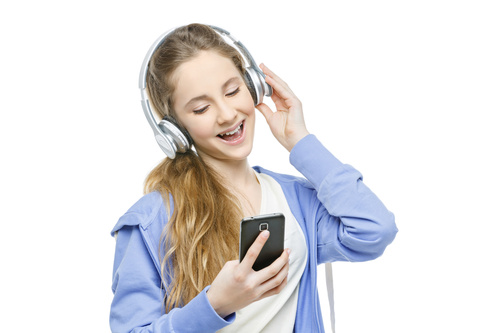 Happy girl listening to music with mobile phone Stock Photo