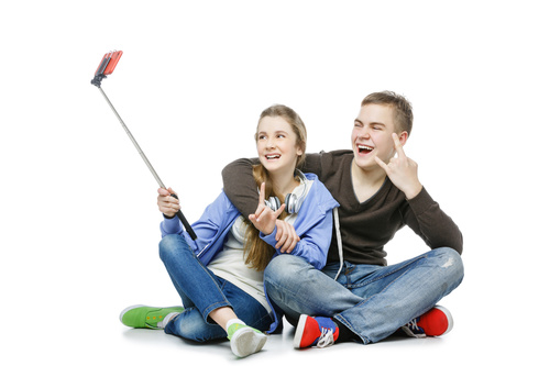 Happy teen boy and girl using a smartphone selfie Stock Photo 01