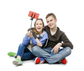 Happy teen boy and girl using a smartphone selfie Stock Photo 02