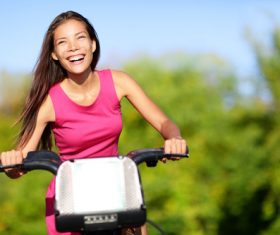 Happy woman riding bicycle Stock Photo