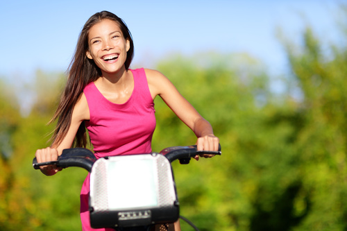 Happy woman riding bicycle Stock Photo