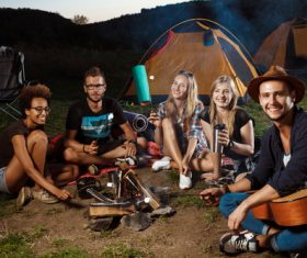 Happy young friends camping Stock Photo