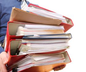 Holding a stack of folders man Stock Photo