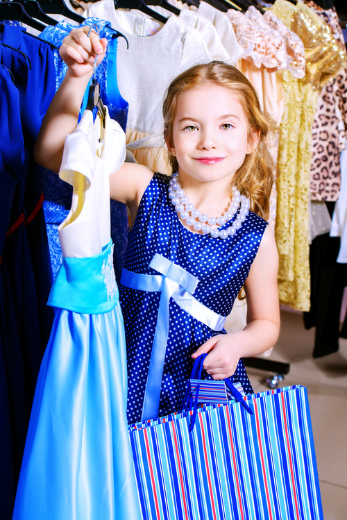 Little girl buying new clothes Stock Photo