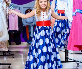 Little girl picking new clothes Stock Photo