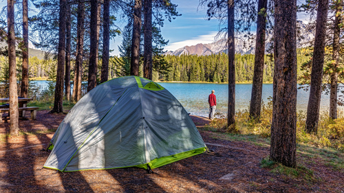 Man camping at the lake Stock Photo