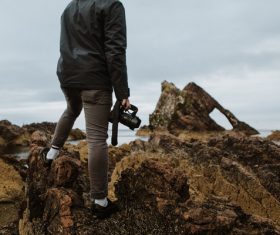 Man enjoying sea scenery with camera Stock Photo