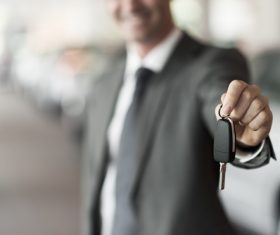 Man holding car key in hand Stock Photo
