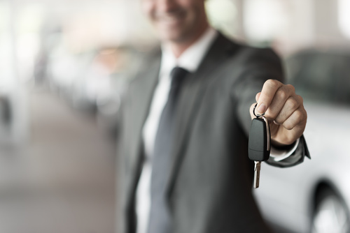 Man holding car key in hand Stock Photo