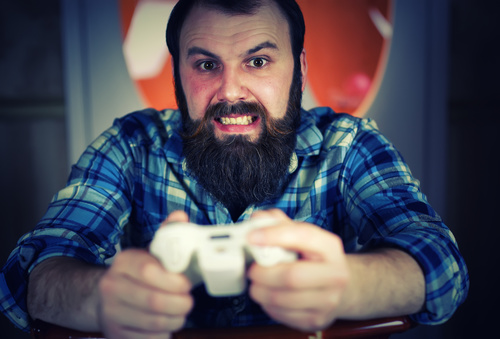 Man playing game excited expression Stock Photo