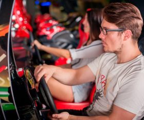 Man playing games in game arcade Stock Photo