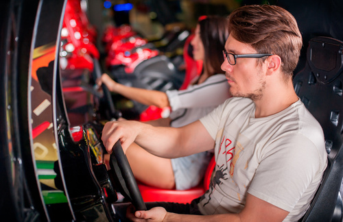 Man playing games in game arcade Stock Photo