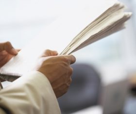 Man reading newspaper Stock Photo