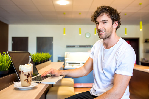 Man relaxing at home and surfing the internet Stock Photo