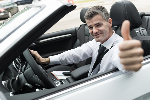 Man sitting in the car with thumbs up Stock Photo