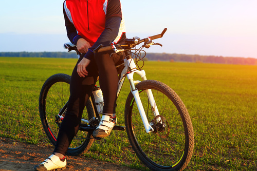 Man sitting resting on bicycle Stock Photo