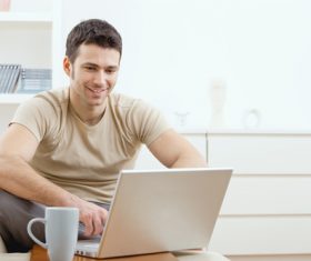 Man surfing the internet at home Stock Photo 01