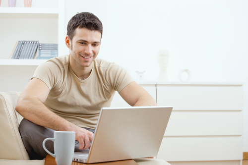 Man surfing the internet at home Stock Photo 01