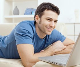 Man surfing the internet at home Stock Photo 02