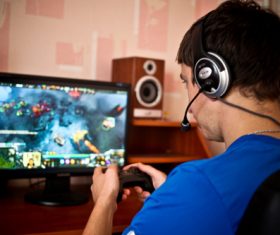 Man uses game handle to play games Stock Photo 01