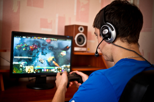 Man uses game handle to play games Stock Photo 01