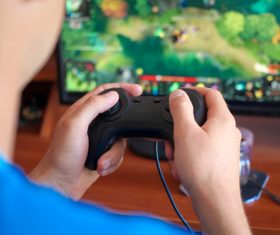 Man uses game handle to play games Stock Photo 02