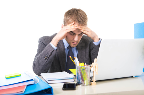 Man working exhaustedly in the office Stock Photo