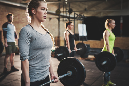 Men and women doing barbell exercises in the gym Stock Photo 01