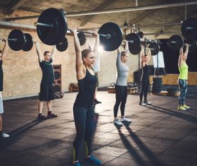 Men and women doing barbell exercises in the gym Stock Photo 02